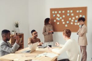 A diverse group of professionals engaged in a collaborative discussion during an office meeting.