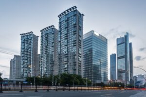 A vibrant city street scene featuring towering buildings that define the urban skyline in the background.